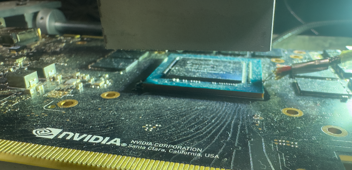 BGA rework nozzle and thermocouple monitoring temperature over a GPU die